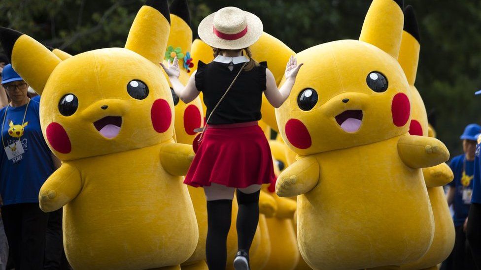 Performers dressed as Pikachu, a character from Pokemon series game titles, march during the Pikachu Outbreak event hosted by The Pokemon Co. on August 10, 2018 in Yokohama, Kanagawa, Japan.