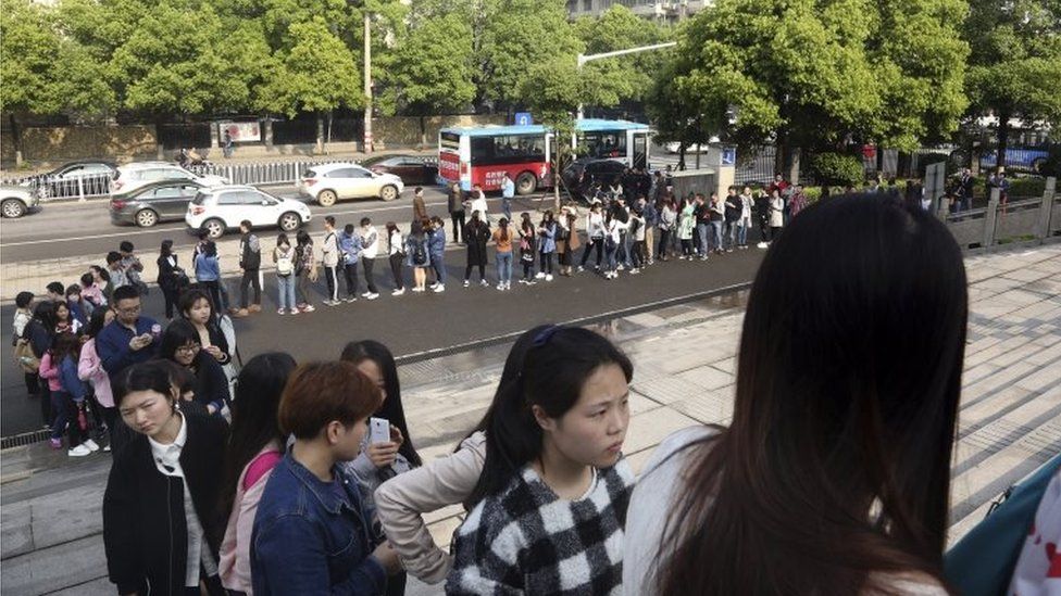 Supporters line up to attend a court session where a gay couple is expected to argue in China's first gay marriage case in Changsha in central China's Hunan province on Wednesday, April 13, 2016.