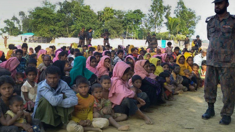 Rohingya Muslims from Myanmar who tried to cross the Naf river into Bangladesh are guarded by Bangladeshi security officials in Teknaf on December 25 2016