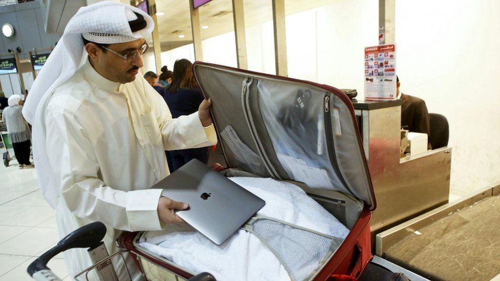 Kuwaiti social media activist Thamer al-Dakheel Bourashed puts his laptop inside his suitcase at Kuwait International Airport in Kuwait City, 23 March