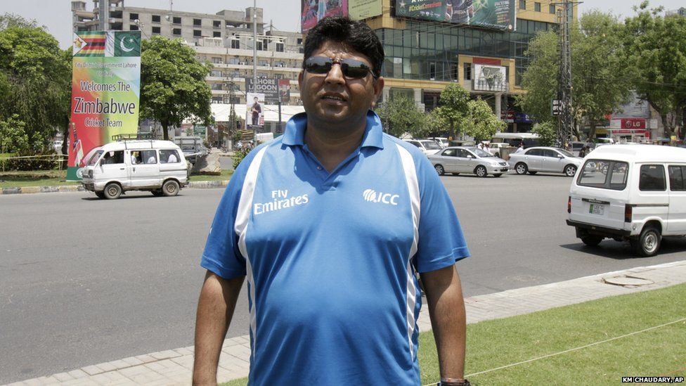 Pakistani cricket umpire Ahsan Raza, poses for a photograph on his way to the stadium in Lahore (20 May 2015)
