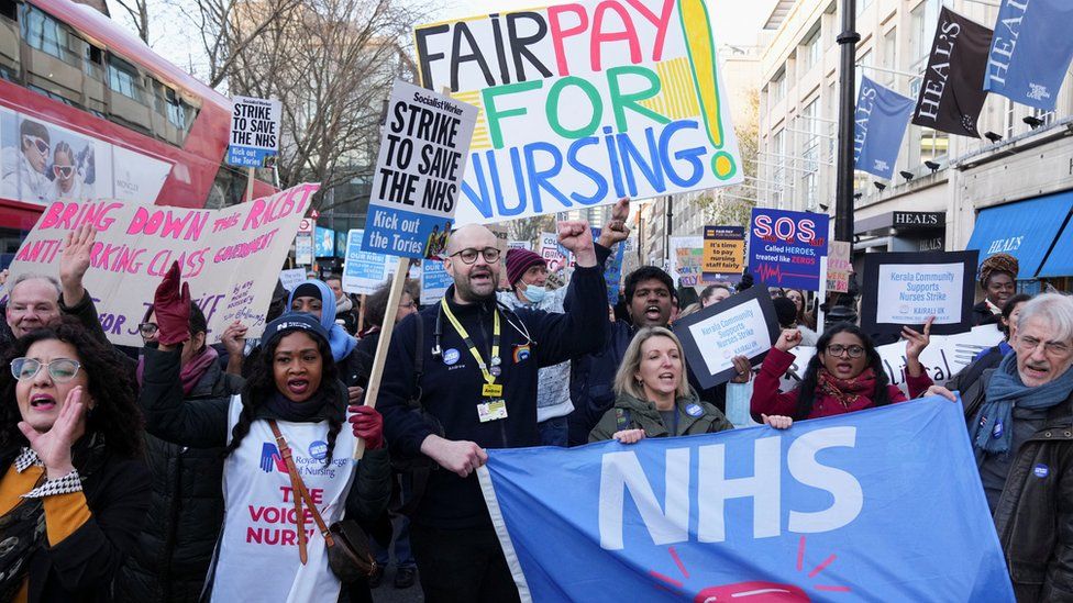 NHS nurses hold signs during a strike in London