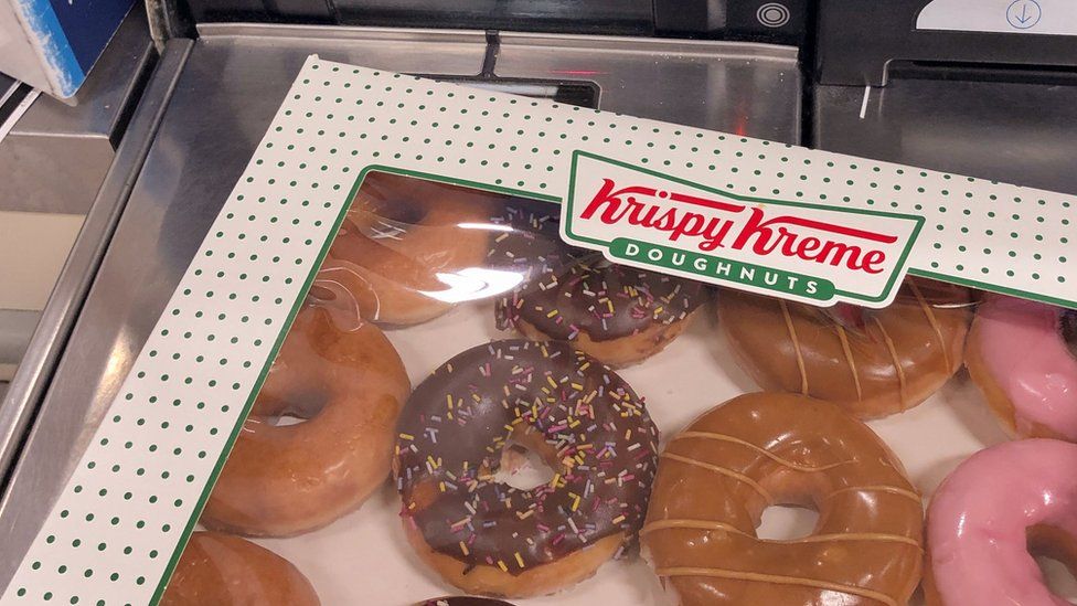 A box of Krispy Kreme donuts on the self-service checkout at a Tesco Extra store in Wisbech, Cambridgeshire