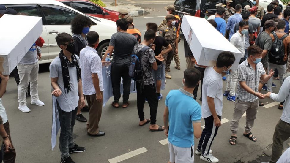 Беженцы на акции протеста в Джакарте, Индонезия, несут гробы