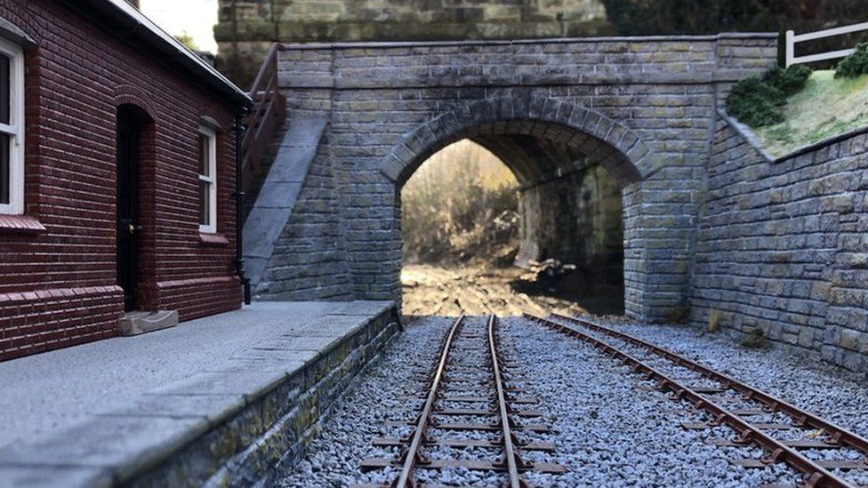 Model of the Glyn Valley Tramway at Chirk, with the real bridge behind it