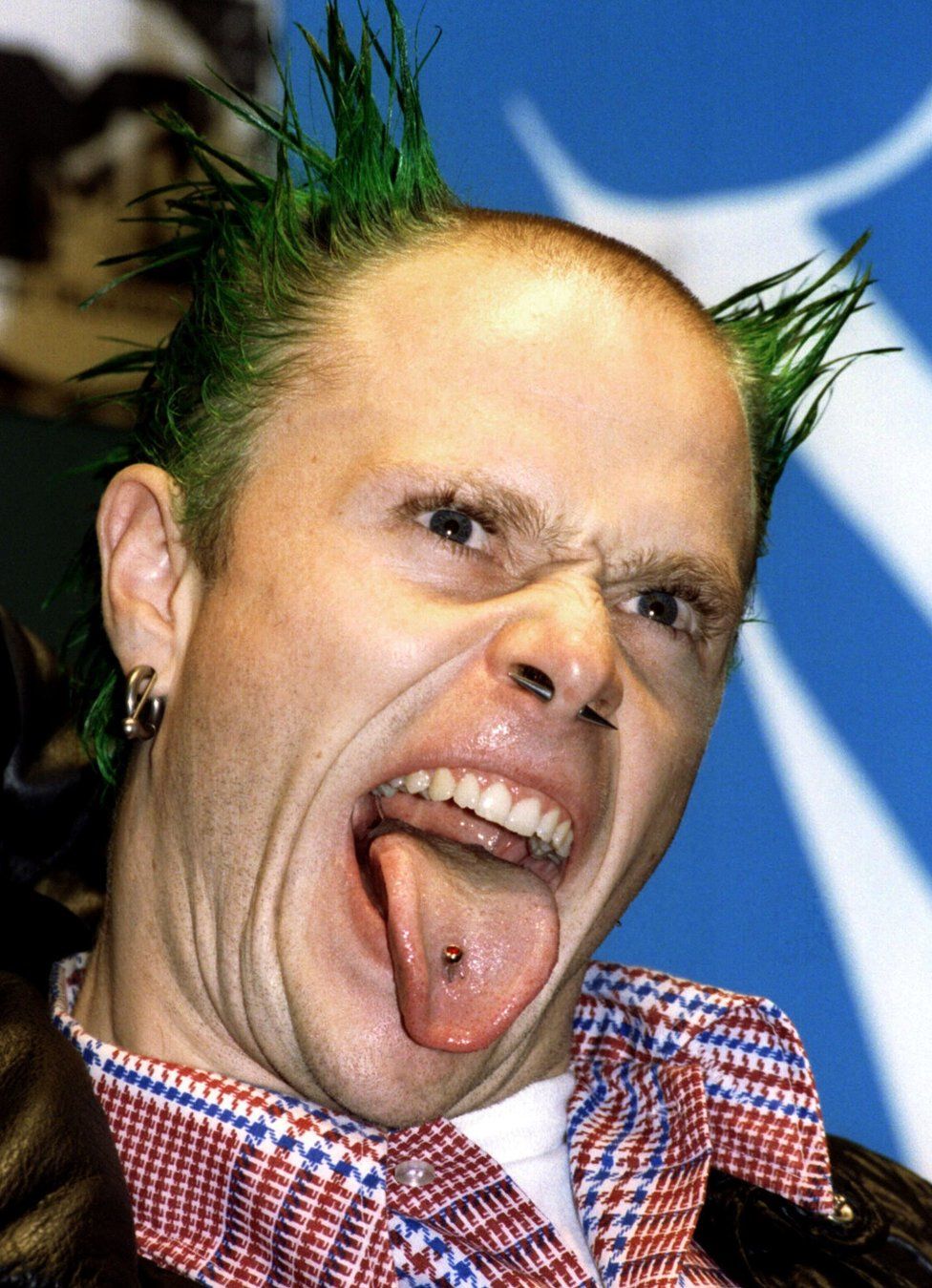 The Prodigy lead singer Keith Flint sticks out his tongue at press photographers during the 1996 MTV Europe Music Awards gala in London