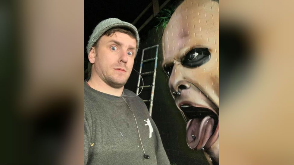 Nathan Murdoch with mural of Keith Flint