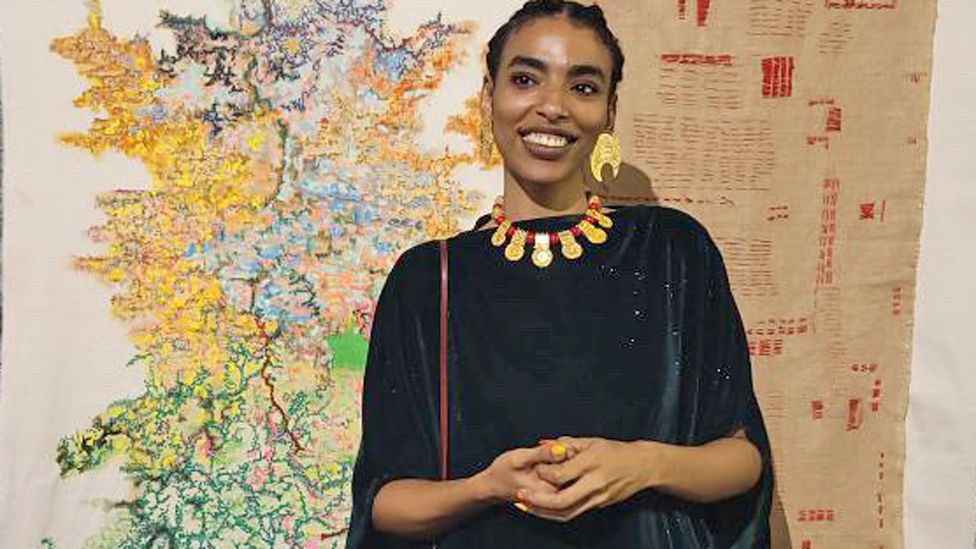 Tibian Bahari in front of one of her works in Nairobi, Kenya - September 2023