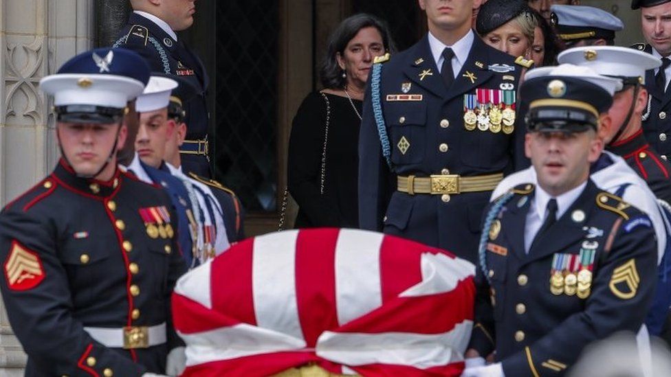 An honour guard carries the casket out after the memorial service for Senator John McCain at the Washington National Cathedral in Washington DC on 1 September 2018