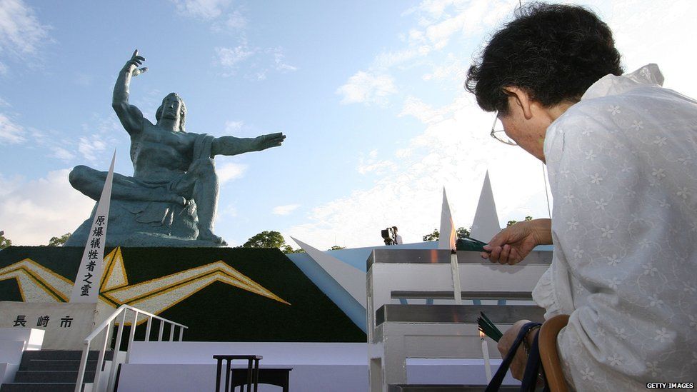 A Japanese woman prays for the victims of an atomic bomb upon the 60th anniversary of the atomic bombing at the Peace Park in Nagasaki on 9 August 2005 in Nagasaki, Japan.