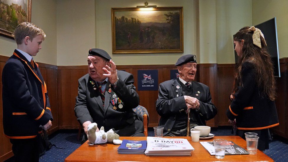 D-Day veterans Richard Aldred (second left), 99, who served with the 7th Armoured Division of Royal Tank Regiment, and Ambassador for the British Normandy Memorial Stan Ford, 98, meeting pupils from Norfolk House School during 'Meet the Veterans: A History Lesson With Those Who Were There'