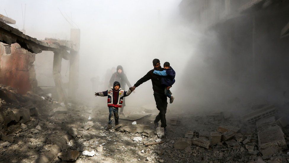 Syrian civilians flee from reported regime air strikes in the rebel-held town of Jisreen