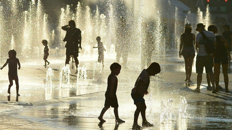 Children play in the water fountains at the Place des Arts in Montreal, Canada on a hot summer day July 3, 2018.