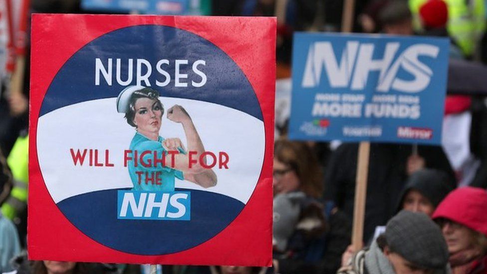 placard in march reading nurses will fight for the nhs