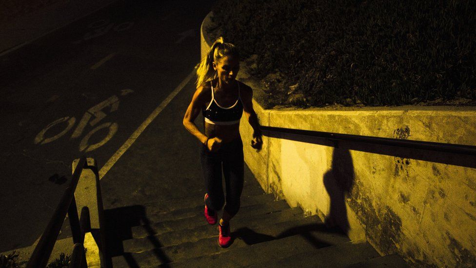 Woman running at night