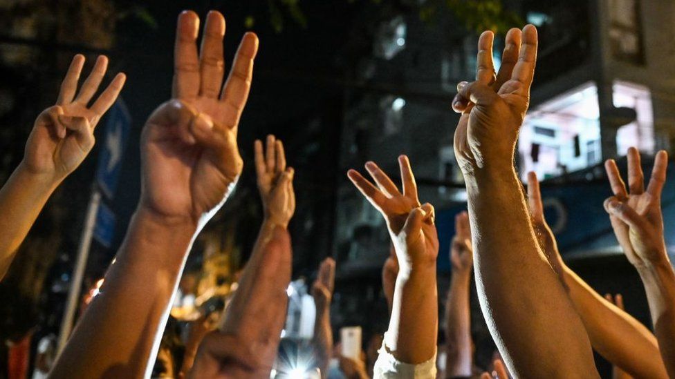 People give a three-finger salute at a protest in Yangon