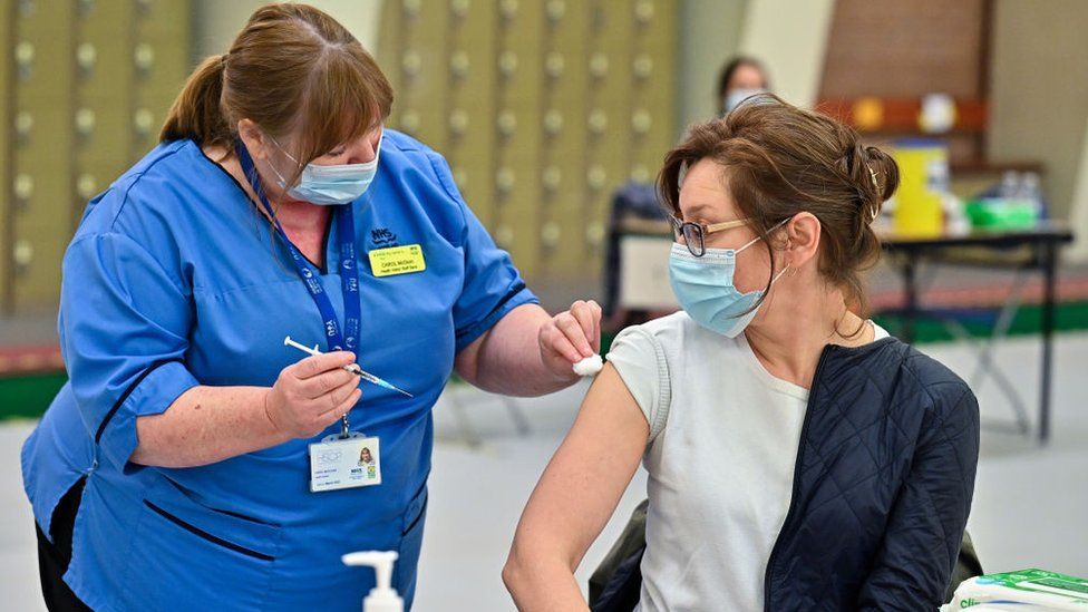 File pic of woman being vaccinated in Glasgow