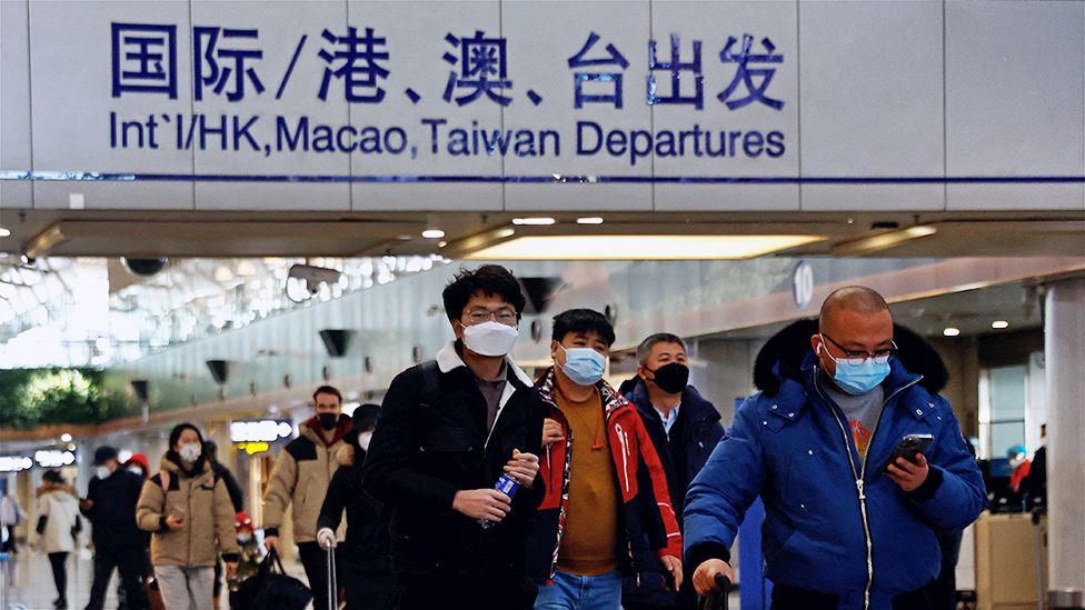 Travellers walk with their luggage at Beijing Capital International Airport, amid the coronavirus disease (COVID-19) outbreak in Beijing, China December 27, 2022.
