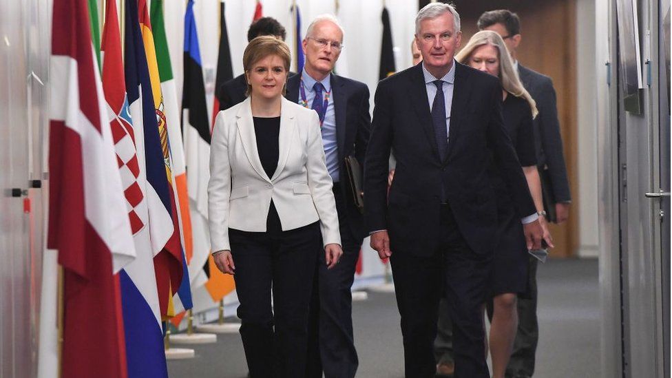 EU Chief negotiator for Brexit Michel Barnier (R) welcomes the first minister at the European Commission in Brussels