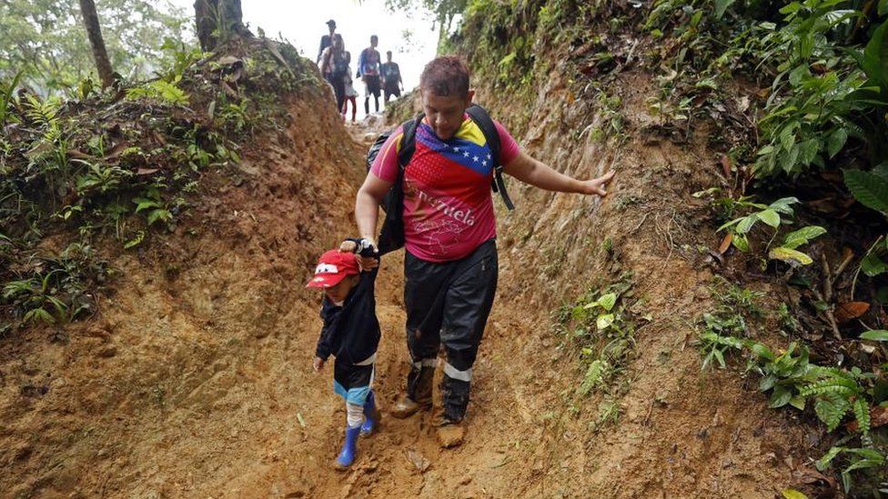 Migrants walk through a mountain with the intention of reaching Panama, through the Darien Gap, Colombia, on 08 October 2022