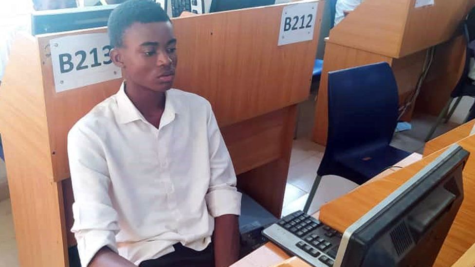 Christian Asogwa at a computer during his monthly assessment at nearby Institute of Management and Technology (IMT) in Enugu, Nigeria