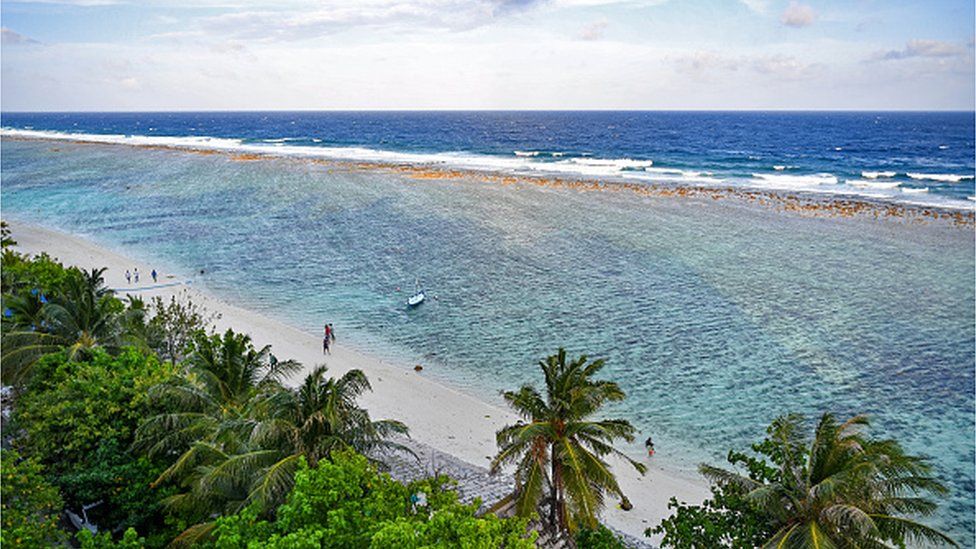 A general view shows people at a beach in Hulhumale on December 26, 2023.