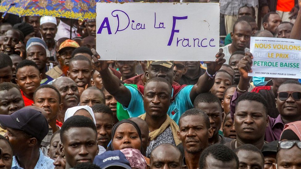 A protesters holds a sign saying 'goodbye France' at a rally in Niamey last month
