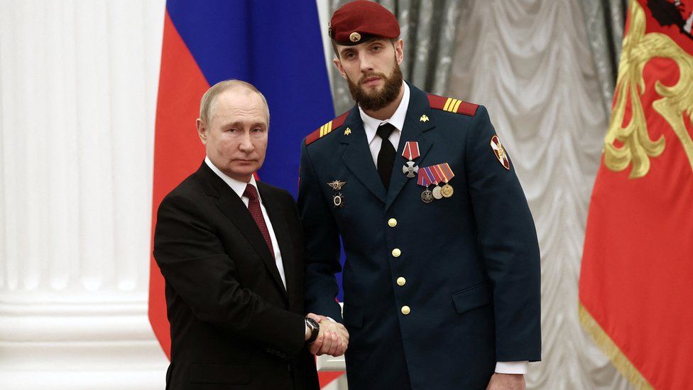 Vladimir Putin awards sergeant of the Russian National Guard Troops, Lev Makeyev, with the Order of Courage during a ceremony at the Kremlin