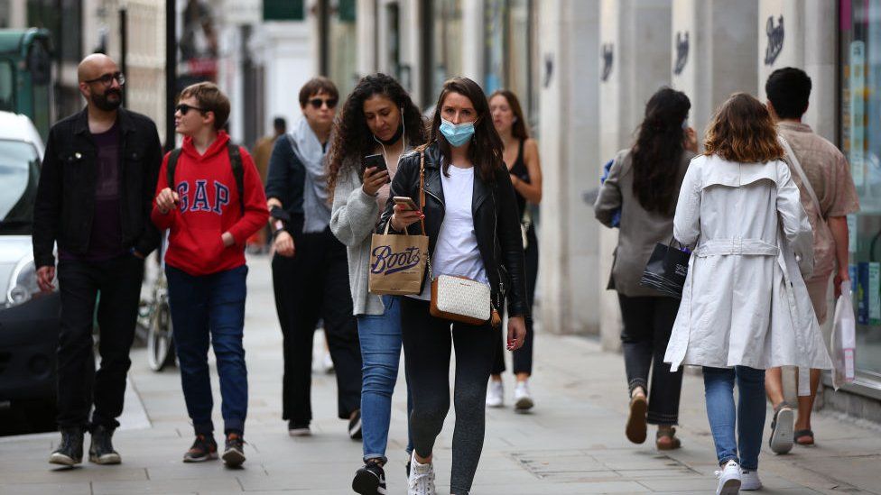 Shoppers wearing masks in street