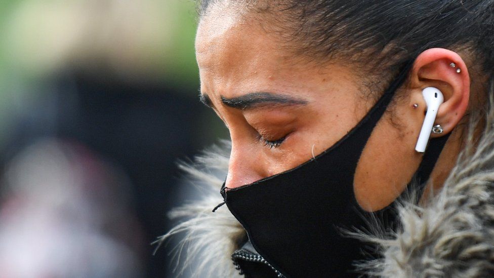 A woman cries at the memorial site