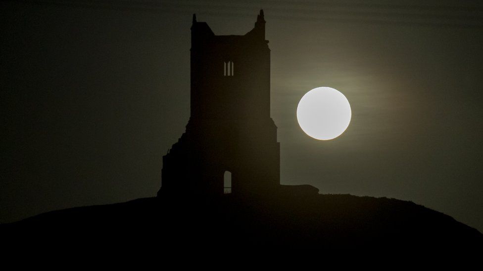 Moon next to a church