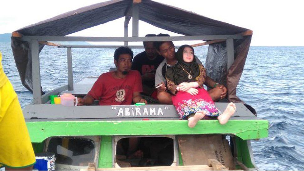 A recent undated handout picture released by Indonesian police and made available on 3 May 2016 shows an Indonesian man holding a sex doll in Banggai in Sulawesi.