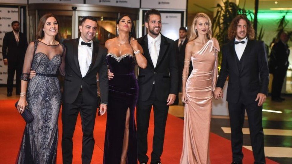 Former Barcelona players Xavi Hernandez, Cesc Fabregas and Carles Puyol and their wives pose on a red carpet upon arrival to attend Argentine football star Lionel Messi and Antonella Roccuzzo"s wedding in Rosario, Santa Fe province, Argentina on 30 June 2017