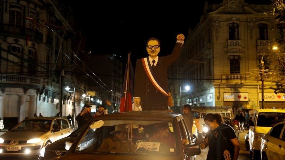 A cardboard figure depicting former Chilean President Salvador Allende is seen on the roof of a car after people voted during a referendum on a new Chilean constitution, in Valparaiso, Chile October 25, 2020