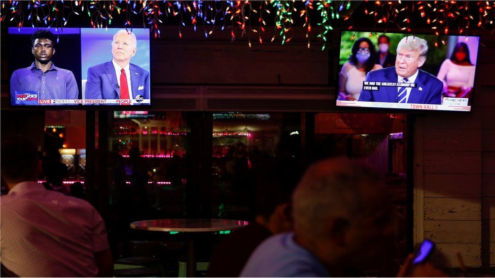People watch the dual town halls of Democratic presidential candidate Joe Biden and President Donald Trump at a restaurant in Florida