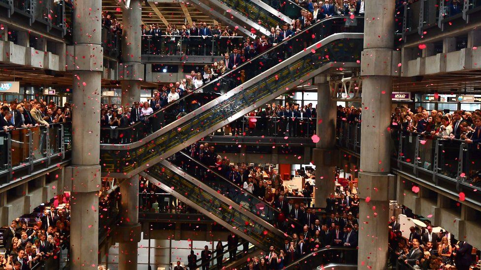 Poppies fall through the atrium of the Lloyd"s building during the Lloyd"s of London Armistice commemoration service.