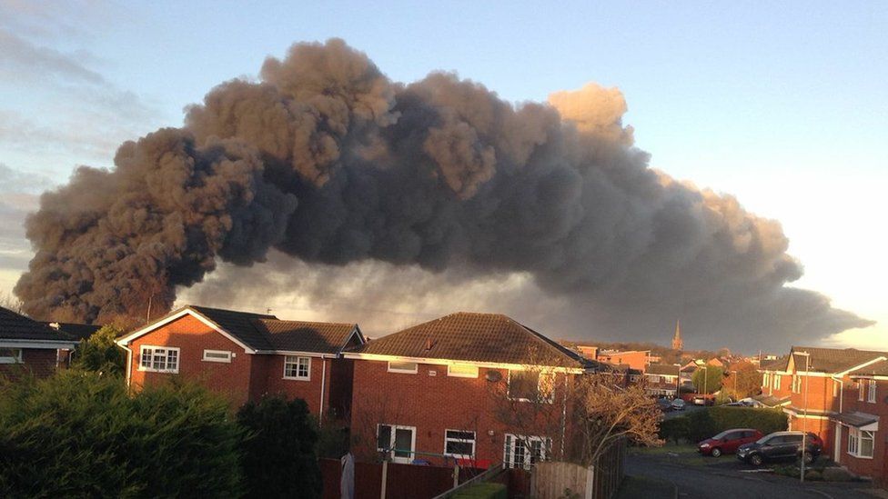 Plume of smoke near the motorway caused by fire