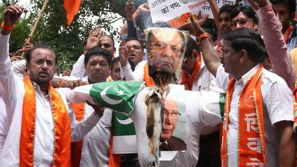 Activists of India's right-wing Shiv Sena burn an effigy depicting Pakistani Prime Minister Nawaz Sharif and his advisor on National Security and Foreign Affairs Sartaj Aziz