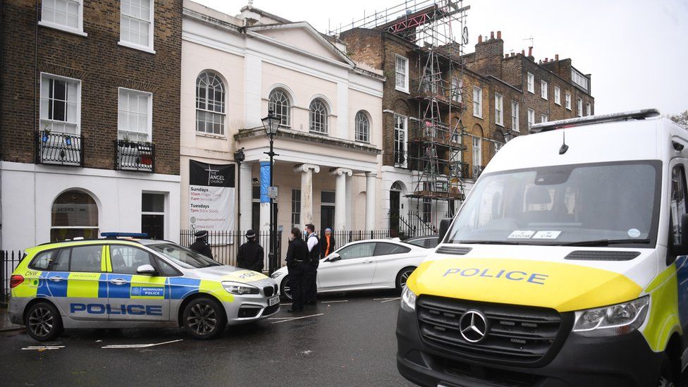 Police gather outside the Angel Church in north London, Britain,