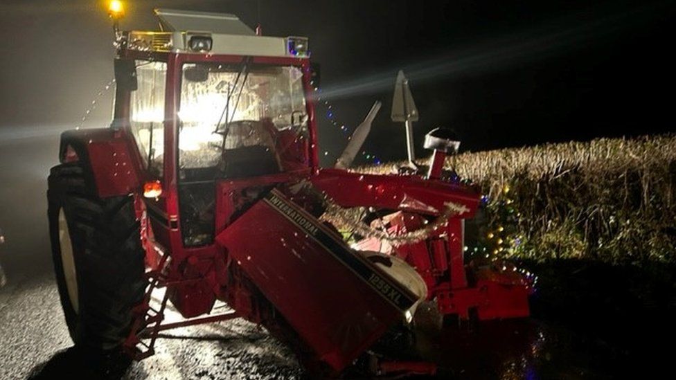 Damaged tractor covered in fairy lights