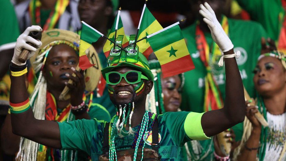 Senegal's supporters cheer during the Africa Cup of Nations (CAN) 2021 final football match between Senegal and Egypt at Stade d'Olembe in Yaounde on February 6, 2022
