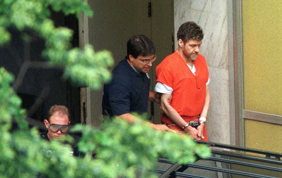 Theodore Kaczynski, (R-top) is escorted by US Marshalls outside the Sacramento County Federal Court 04 May in Sacramento, CA.