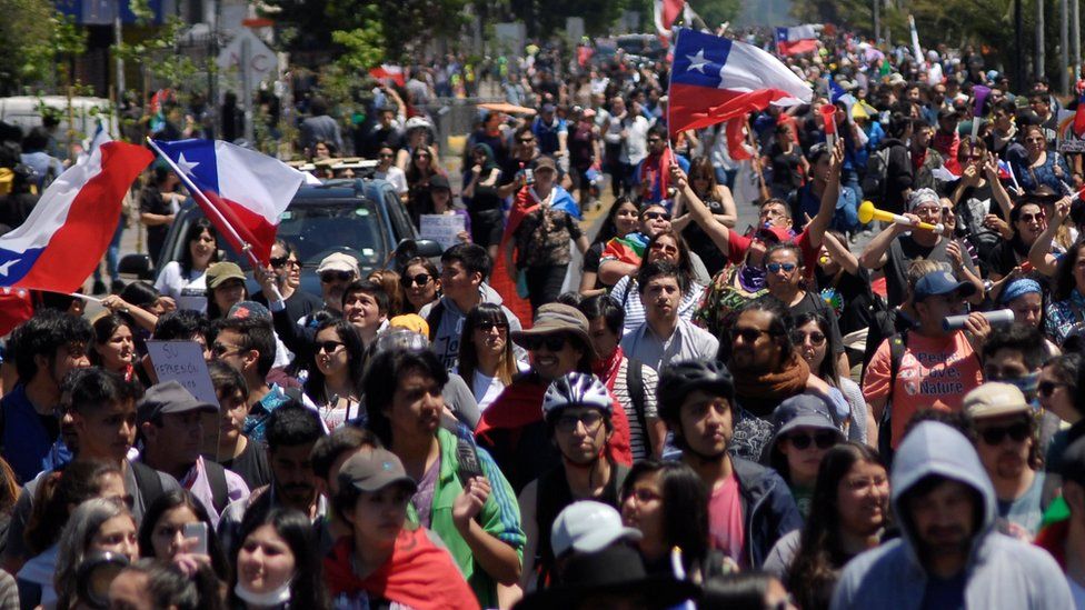Demonstrators march against Chile's government in Concepcion, Chile, 12 November, 2019.
