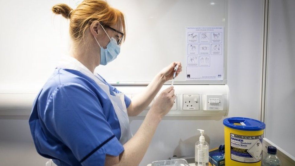 A nurse preparing a coronavirus vaccine