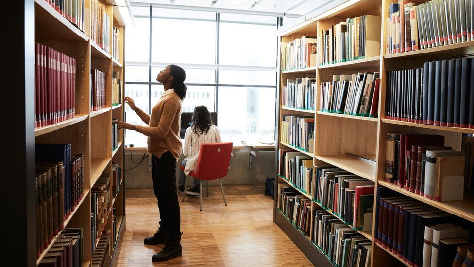 Students search the shelves at a university library