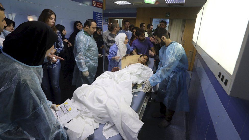 Medics help an injured child inside a hospital after suicide bombers targeted Beirut's southern suburbs (12 November 2015)