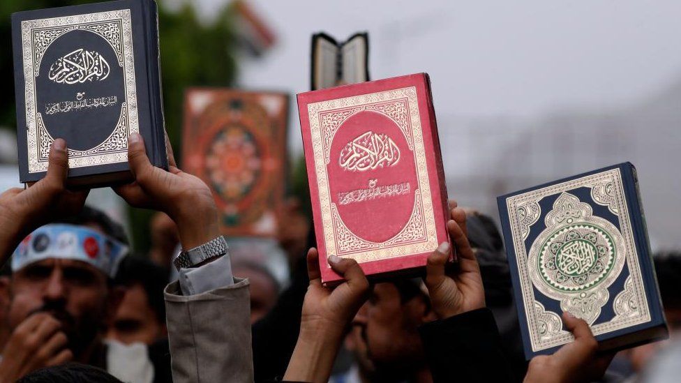 Yemenis hold up copies of the Koran during a protest against the desecration and burning of the Koran, in Sana'a, Yemen, 24 July 2023