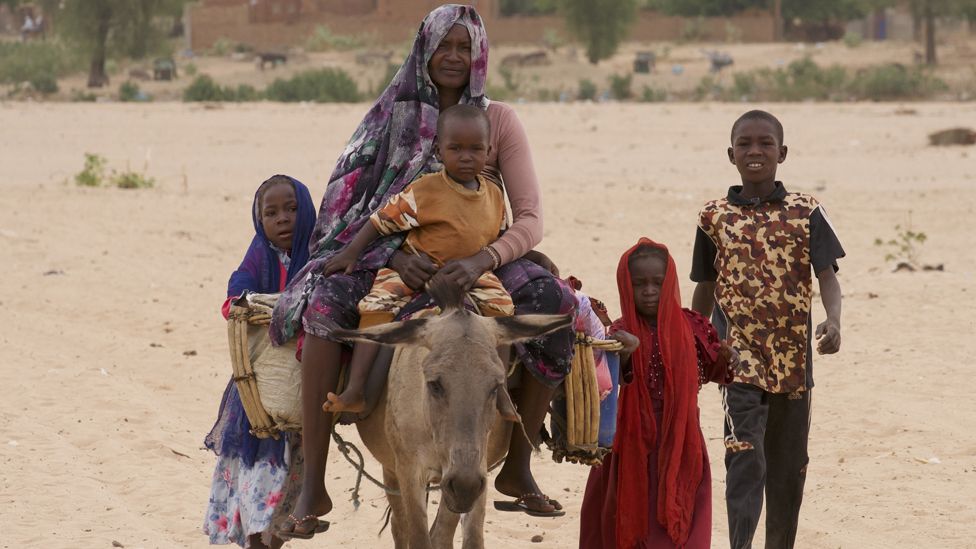 Family travelling with a donkey