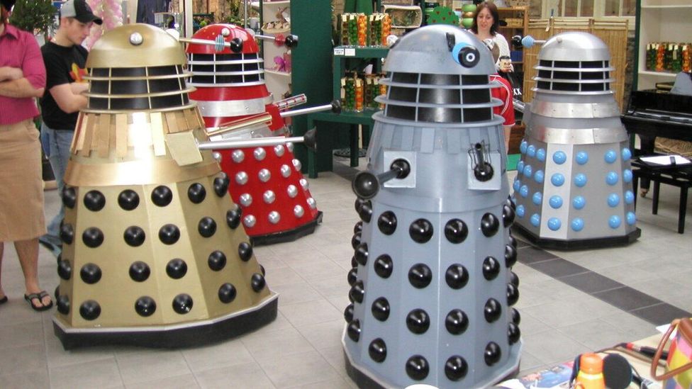 Four daleks in a busy shopping centre.