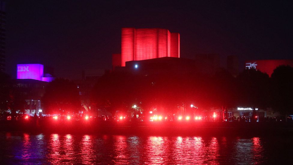 National Theatre lit up in red